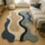 Modern abstract handmade tufted wool area rug with organic wave design for living room