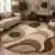 Modern abstract tufted area rug in beige and olive green with organic curved design