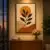 Handmade tufted botanical wall hanging with cream background, mustard-orange sun, green leaves, and terracotta shapes