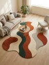 Abstract wave rug in rust orange, forest green and cream under a round wooden coffee table