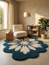 Blue and ivory daisy flower tufted rug with scalloped edge in a reading corner with a bouclé chair