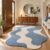 Coastal blue wavy rug with blue and cream waves in a bright entryway