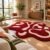 Crimson flow abstract rug with cream flowing lines in a sunlit living room