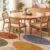 Dining table tufted rug with mustard, olive and terracotta petals under a round table